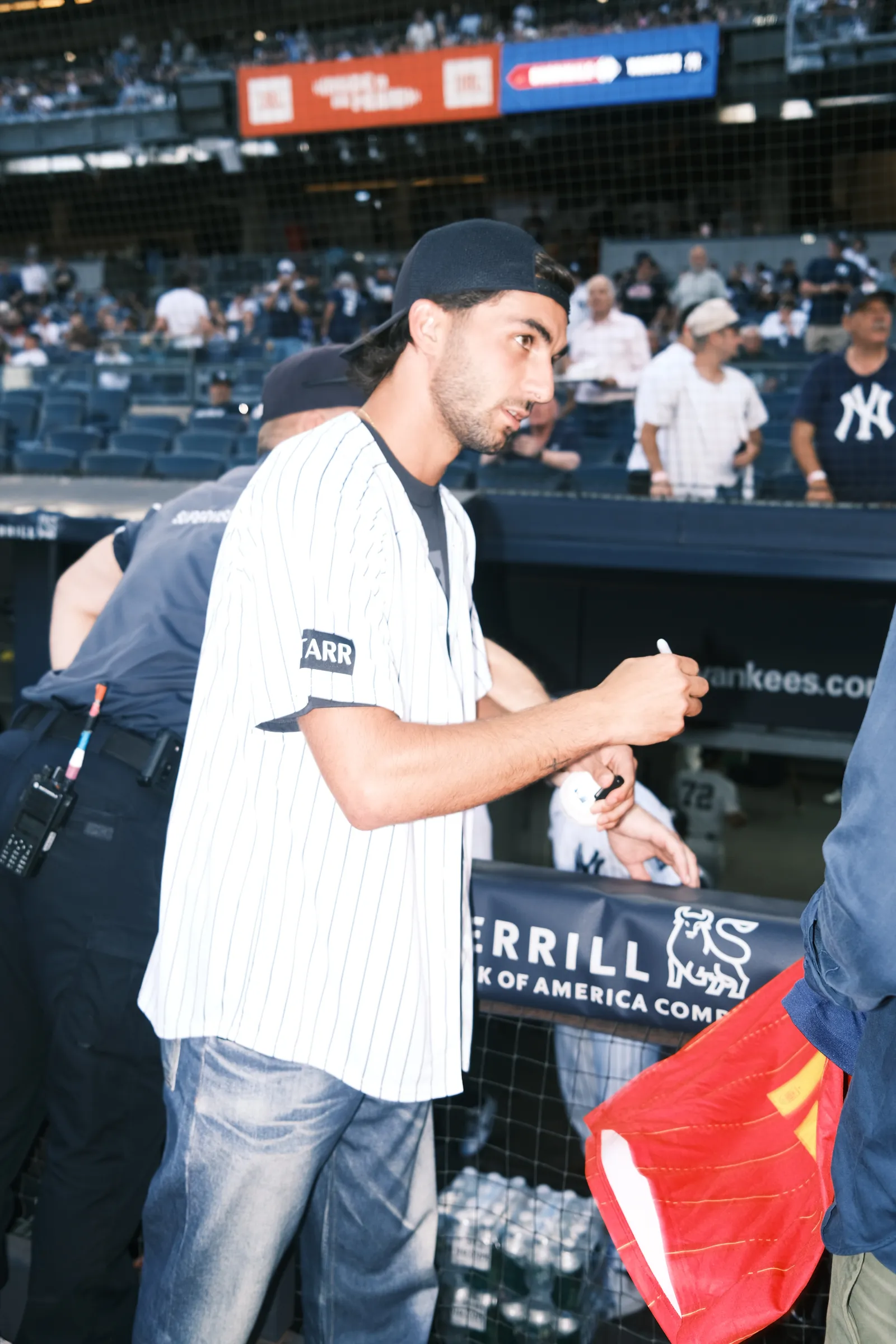 Image may contain Wally Backman Jonathan Cyprien Adult Person Baseball Cap Cap Clothing Hat Jeans Pants and Face